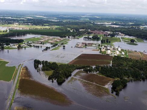 Aerial photograph of flooding covering fields and roads.